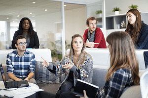 a group of people talking indoors